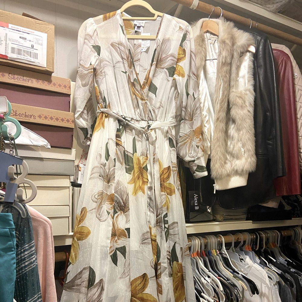 Floral long flowing skirt, has a crisscross neckline and long sleeves.